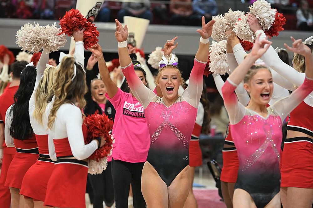 Junior Krista Zultevicz runs through a tunnel during the transition from the bar apparatus to beam during the meet against UNC-Chapel Hill and Western Michigan at Reynolds Coliseum on Saturday, Feb. 4, 2023. NC State won the meet with an overall score of 196.275.