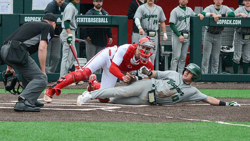 Freshman catcher Cannon Peebles gets an opponent out during the game against Wagner on Doak Field at Dail Park on Sunday, Feb. 19, 2023. The Wolfpack beat the Seahawks 9-0.