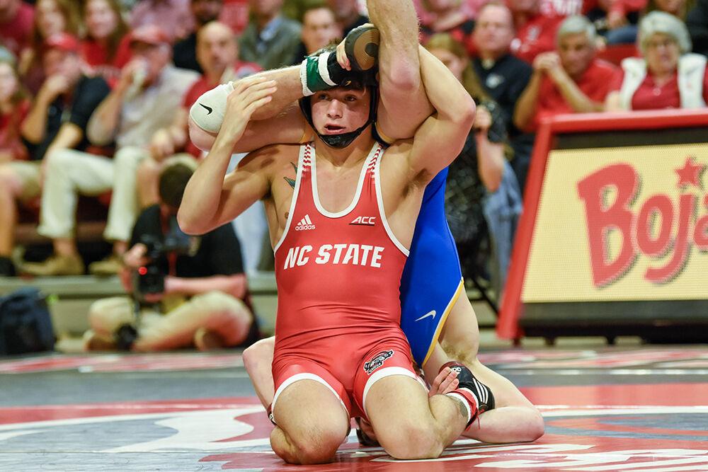Freshman Jackson Arrington flips his opponent over his shoulders during the NC State duel against Pitt in&#160;Reynolds Coliseum on Friday, Feb. 10, 2023. Arrington won the 149 bout 4-0. NC State beat Pitt 23-9.