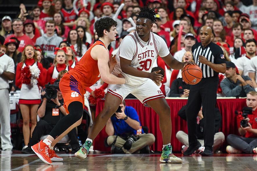 Graduate forward DJ Burns attempts to get past an opponent during the game against Clemson in PNC Arena on Saturday, Feb. 25, 2023. Burns had 24 points. The Wolfpack lost to the Tigers 96-71.