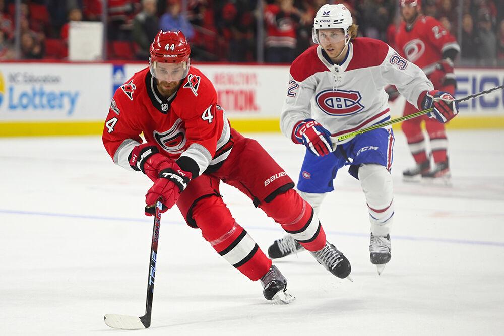 Carolina Hurricanes defenseman Calvin de Haan dribbles the puck during the game against the Montreal Canadiens in PNC Arena on Thursday, Feb. 16, 2023. The Hurricanes won 6-2.