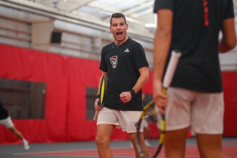 Senior Martins Rocens celebrates a point during the tennis match against North Carolina Central University at J.W. Isenhour Tennis Center on Wednesday, Feb. 8, 2023. The Wolfpack beat the Eagles 7-0.