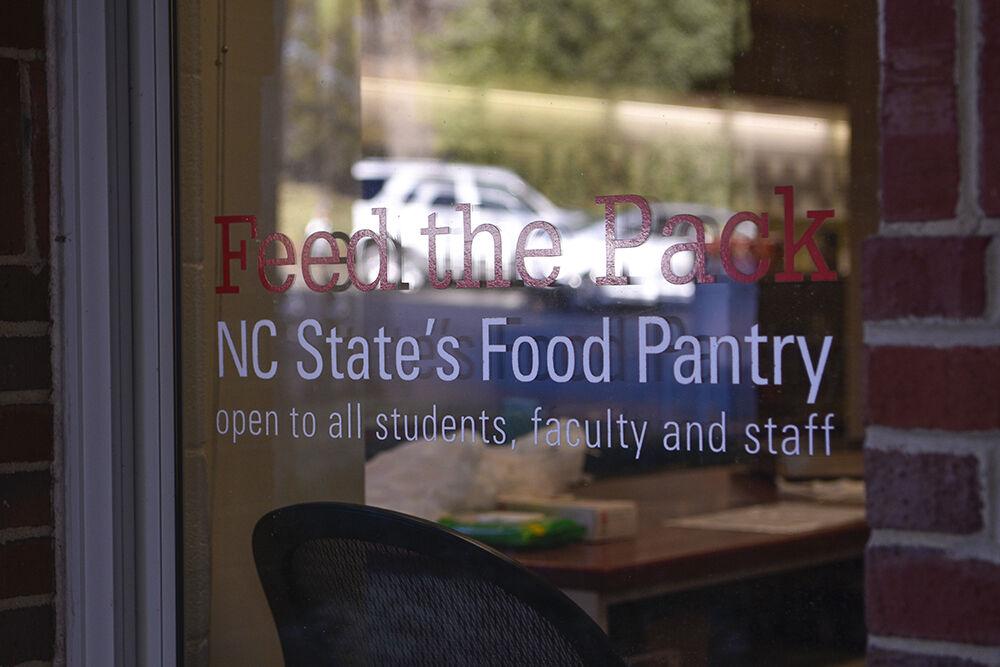 The Feed the Pack sign sits in Quad Commons on NC State Campus on Wednesday, Feb. 9, 2022. Feed the Pack is a food pantry that is open to NC State students, faculty, and staff who struggle with food insecurity. Tara Esmailian, a volunteer of the food pantry and a third-year in nutrition science, states, "I know how food insecurity can impact people, and a lot of students and staff face this problem. If we can alleviate any of that stress it is important to do so."
