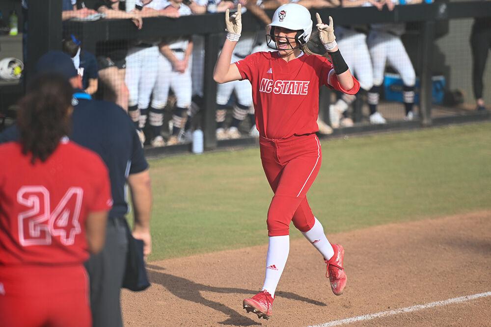 Sophomore infielder Taylor Ensley throws up a wolfie during the game against the Penn Quakers at Dail Softball Stadium on Friday, Feb. 24, 2023. Ensley scored three runs with two home runs during the game. The Wolfpack beat the Quakers 15-6.