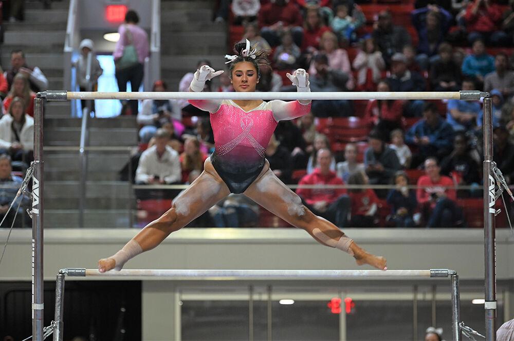 Senior Alexis Ortega leaps to the upper bar in her bar routine during the meet against UNC-Chapel Hill and Western Michigan at Reynolds Coliseum on Saturday, Feb. 4, 2023. NC State won the meet with an overall score of 196.275.