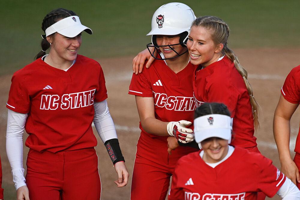 Sophomore infielder Taylor Ensley celebrates her home run with freshman outfielder Ellie Goins and freshman pitcher Madison Inscoe during the game against the Penn Quakers at Dail Softball Stadium on Friday, Feb. 24, 2023. Ensley scored three runs with two home runs during the game. The Wolfpack beat the Quakers 15-6.