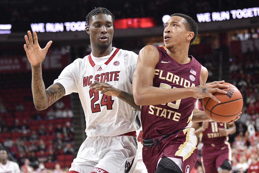 Sophomore forward Ernest Ross defends opponent during the game against the Florida State Seminoles inside PNC Arena on Wednesday, Feb. 1, 2023. The Wolfpack won 94-66.
