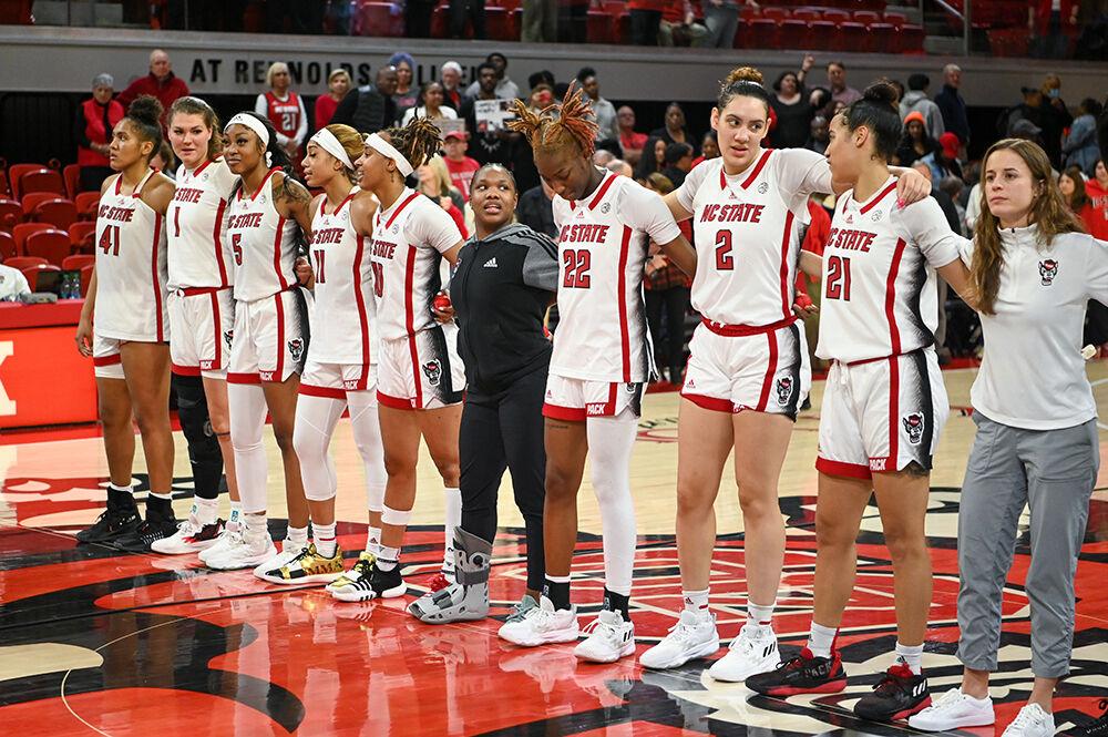 The women's basketball team stands together for the playing of NC State's alma mater after the game against Pitt inside Reynolds Coliseum on Sunday, Feb. 26, 2023. NC State beat Pitt 68-63.