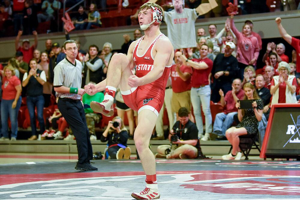 Sophomore Ed Scott celebrates his win during the match against Pittsburgh at William Neal Reynolds Coliseum on Friday, Feb. 10, 2023. Scott won his match 15-3. NC State beat Pittsburgh 23-9.