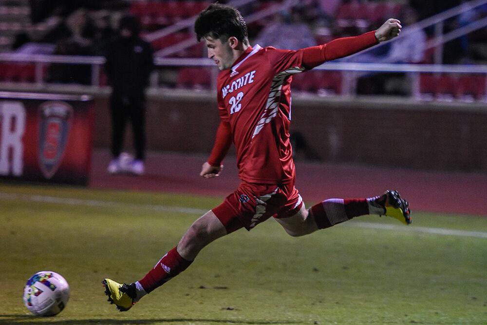 Graduate midfielder Conor Kelly kicks the ball during the Wolfpack's home soccer match against the William &amp; Mary Tribe on Tuesday, Oct. 18, 2022 at Dail Soccer Field. The Wolfpack beat the Tribe 2-1.