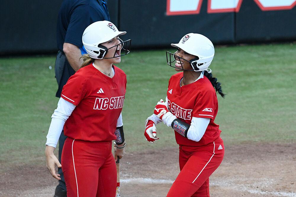 Graduate outfielder Rebecca Murray (left) and freshman utility player Makayla Marbury (right) cheer after running home in the game against Iowa at Dail Softball Stadium on Saturday, Feb. 18, 2023. NC State beat Iowa 3-1.