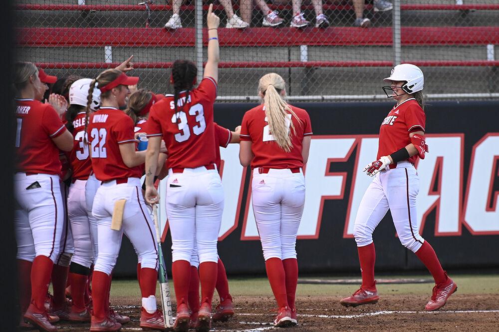 Members of the NC State softball team celebrates a home run made by sophomore infielder Taylor Ensley during the game against Elon at Dail Softball Stadium on Wednesday, Feb. 22, 2023. NC State beat Elon 11-3.