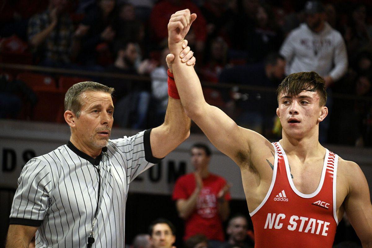 Freshman Jackson Arrington celebrates after winning his match during the NC State duel against Duke in Reynolds Coliseum on Friday, Jan. 27, 2023. Arrington won his individual match10-2. NC State beat duke 46-3.
