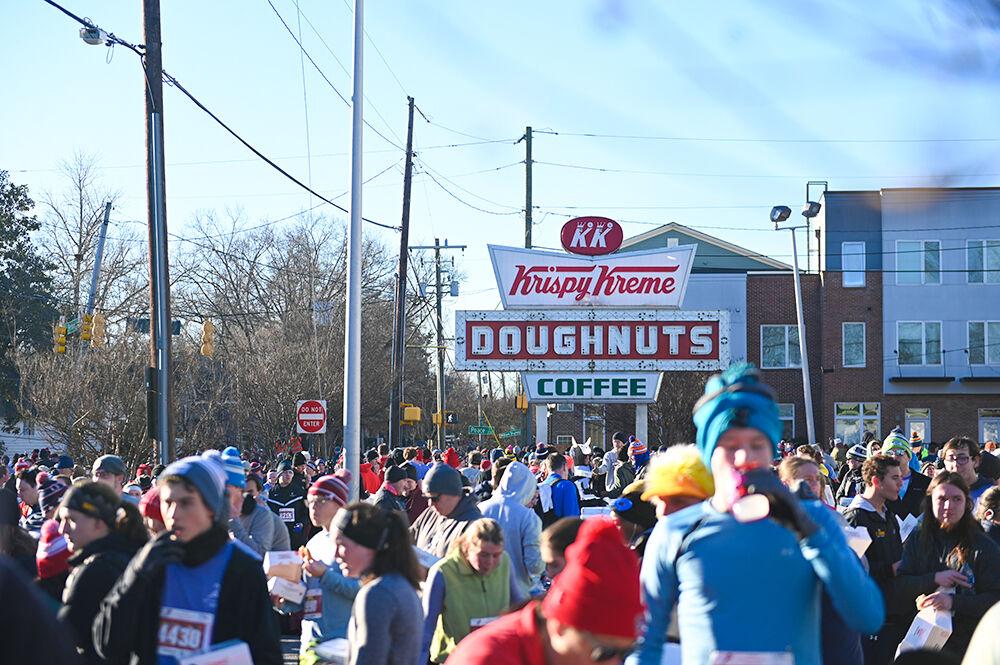 Runners of the 19th annual Krispy Kreme Challenge gather at the Krispy Kreme in Raleigh, NC during the race on Saturday, Feb. 4, 2023. The race consisted of running five miles while eating a dozen donuts where proceeds benefit the UNC Children's Hospital.