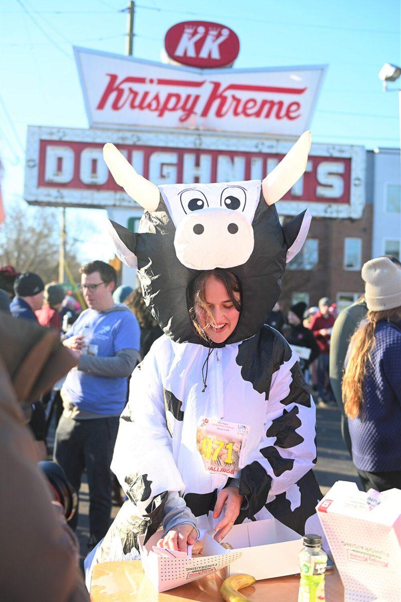 Maddie Clinger, a challenger runner in the 19th annual Krispy Kreme Challenge, eats donuts at the Krispy Kreme in Raleigh, NC during the race on Saturday, Feb. 4, 2023. The race consisted of running five miles while eating a dozen donuts where proceeds benefit the UNC Children's Hospital.