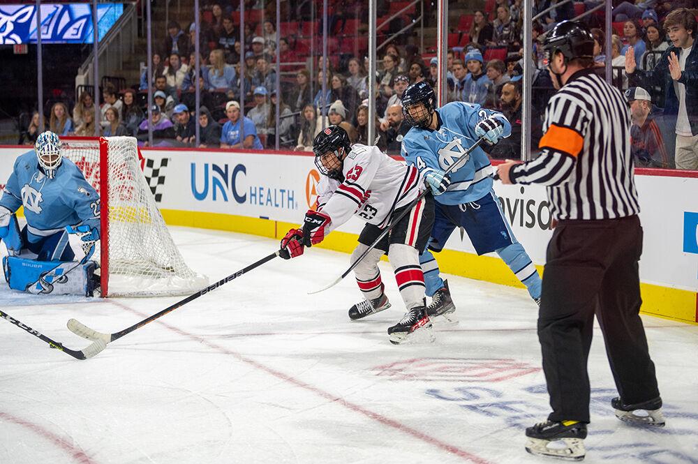 Sophomore forward Philip Bailey defends the puck during the Governor's Cup game against the UNC Tar Heels on Monday, Nov. 21, 2022&#160;in PNC Arena. The Icepack lost to the Tar Heels 4-2.