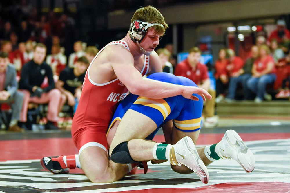 Sophomore Isaac Trumble grapples his opponent during the NC State duel against Pitt in&#160;Reynolds Coliseum on Friday, Feb. 10, 2023. NC State beat Pitt 23-9.