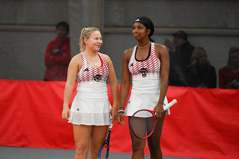 Freshman Diana Shnaider (left) and graduate student Alana Smith talk between sets during the match against Tennessee at J.W. Isenhour Tennis Center on Sunday, Feb. 5, 2023. NC State beat Tennessee 6-1.