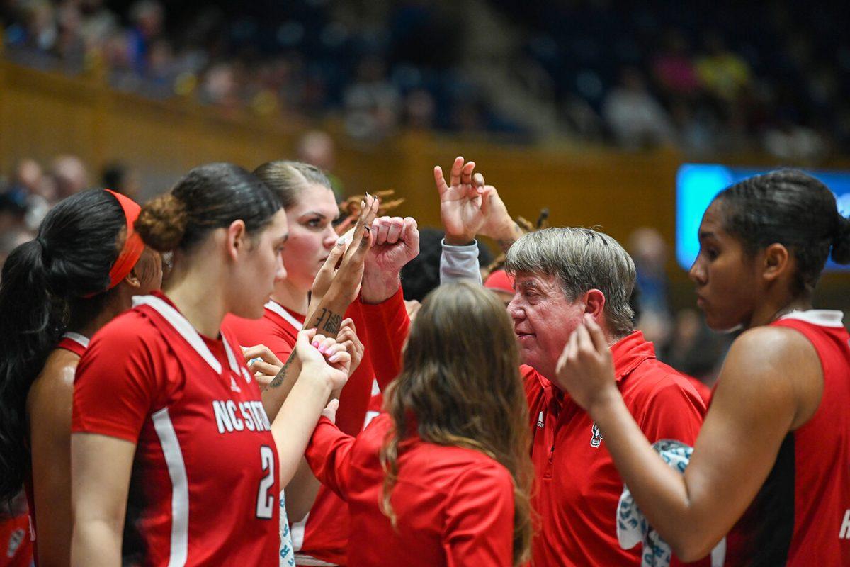 Head coach Wes Moore and the Wolfpack huddle up during a timeout during the game against Duke at Cameron Indoor Stadium on Thursday. Feb. 23, 2023. NC State lost 77-62.