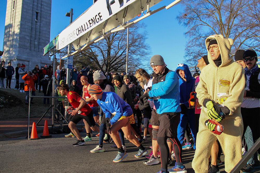 Racers at the starting line begin running the Krispy Kreme Challenge on Hillsborough Street on Feb. 4, 2023. The challenge is an annual charity event where participants attempt to run five miles and eat a dozen donuts at the midpoint of the race, all within an hour.