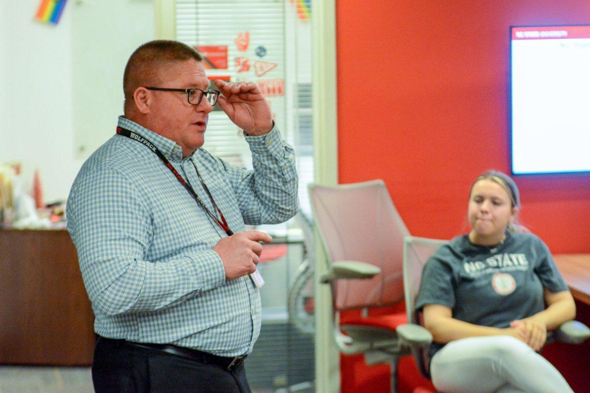 Chief of Police Dan House adjusts his glasses while presenting Campus PD's community involvement for the Chats With Chief event hosted by Student Government in Talley Student Union on Thursday, Feb. 23 2023. House went into explicit detail into policies and involvements offered by Campus Police to NC State students, such as Sexual Assault training and the Safety Escort program. Students can find out more about policies and outreach opportunities offered by Campus Police by visiting their website or by calling (919) 515-3000.