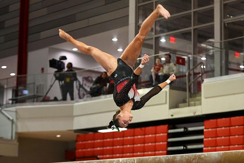 Senior Emily Shepard does a flip on the balance beam during the meet against New Hampshire in Reynolds Coliseum on Friday, Feb. 17, 2023. Shepard finished the meet scoring third overall with a score of 39.075. NC State beat New Hampshire with a final score of 196.150.