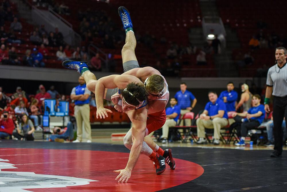 Freshman Dylan Fishback slams his opponent during the 184 bout against Duke in Reynolds Coliseum on Jan. 27, 2023. Fishback won his individual match by fall. NC State beat Duke 46-3.