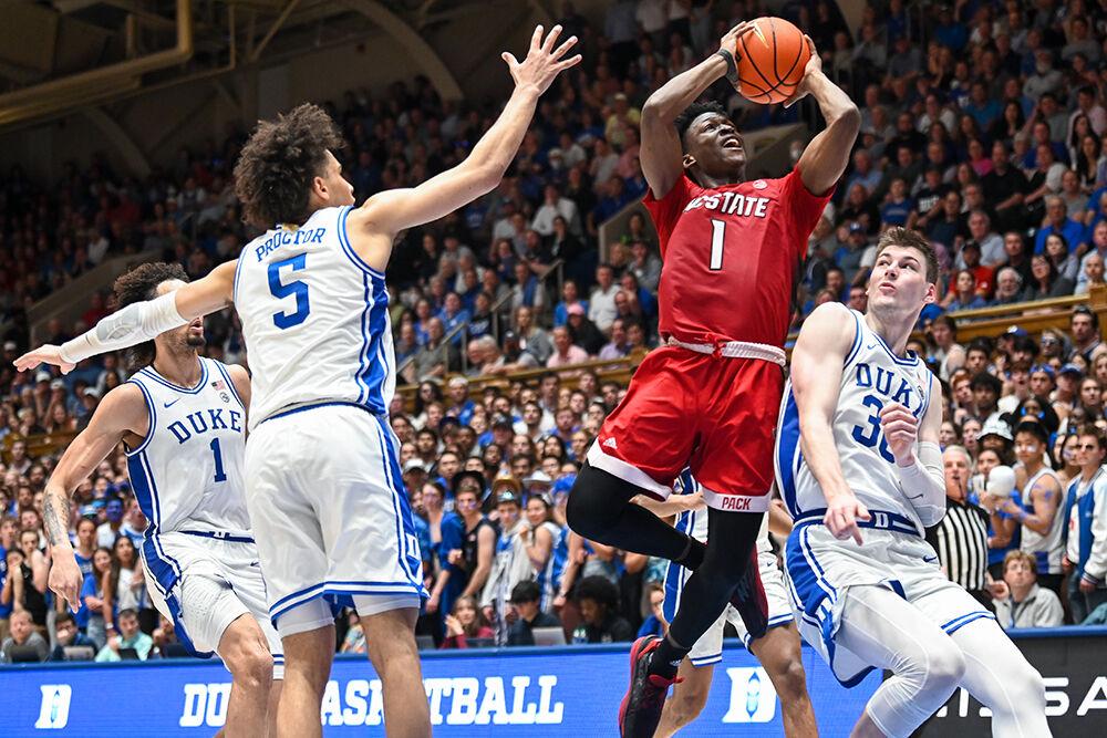 Graduate guard Jarkel Joiner shoots a jump shot as the Duke team surrounds him during the game at Cameron Indoor Stadium on Tuesday, Feb. 28, 2023. Joiner led in scoring for the Wolfpack with 26 points. NC State lost to Duke 71-67.