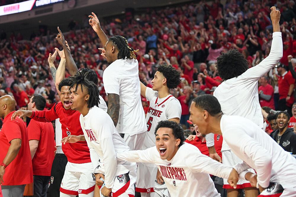 Players on the bench celebrate during the game against UNC-Chapel Hill in PNC Arena on Sunday, Feb. 19, 2023. The Wolfpack beat the Tar Heels 77-69.