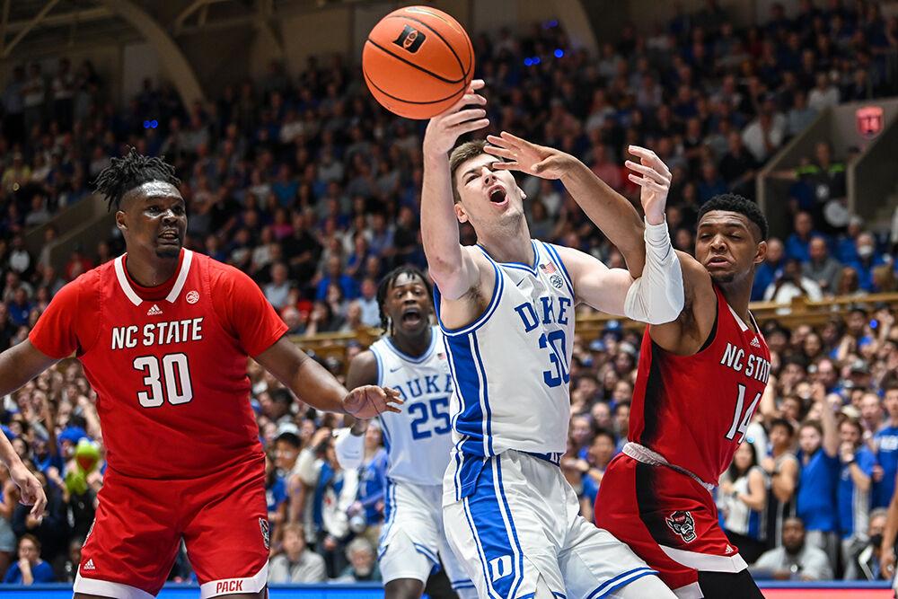 Senior guard Casey Morsell (right) knocks the ball away from Duke freshman center Kyle Filipowski during the game in Cameron Indoor Stadium on Tuesday, Feb. 28, 2023. Morsell made three rebounds for the Wolfpack. NC State lost to Duke 71-67.