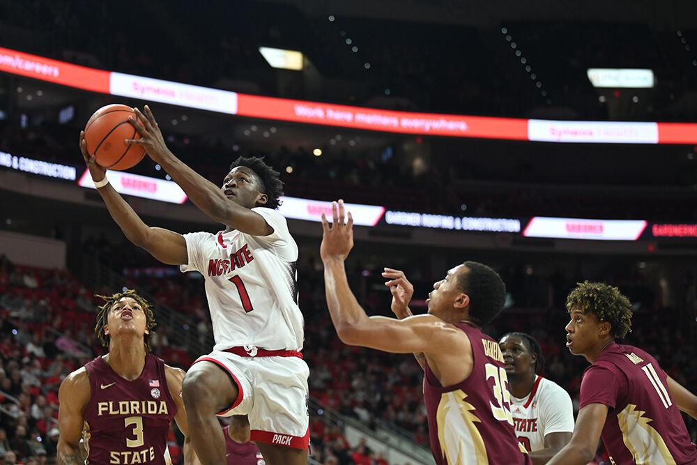 Graduate guard Jarkel Joiner goes up for a layup over Seminole defenders during the Wolfpack's home basketball game against the Florida State Seminoles in PNC Arena on Wednesday, Feb. 1, 2023. Joiner shot for 14 points as the Wolfpack beat the Seminoles 94-66.
