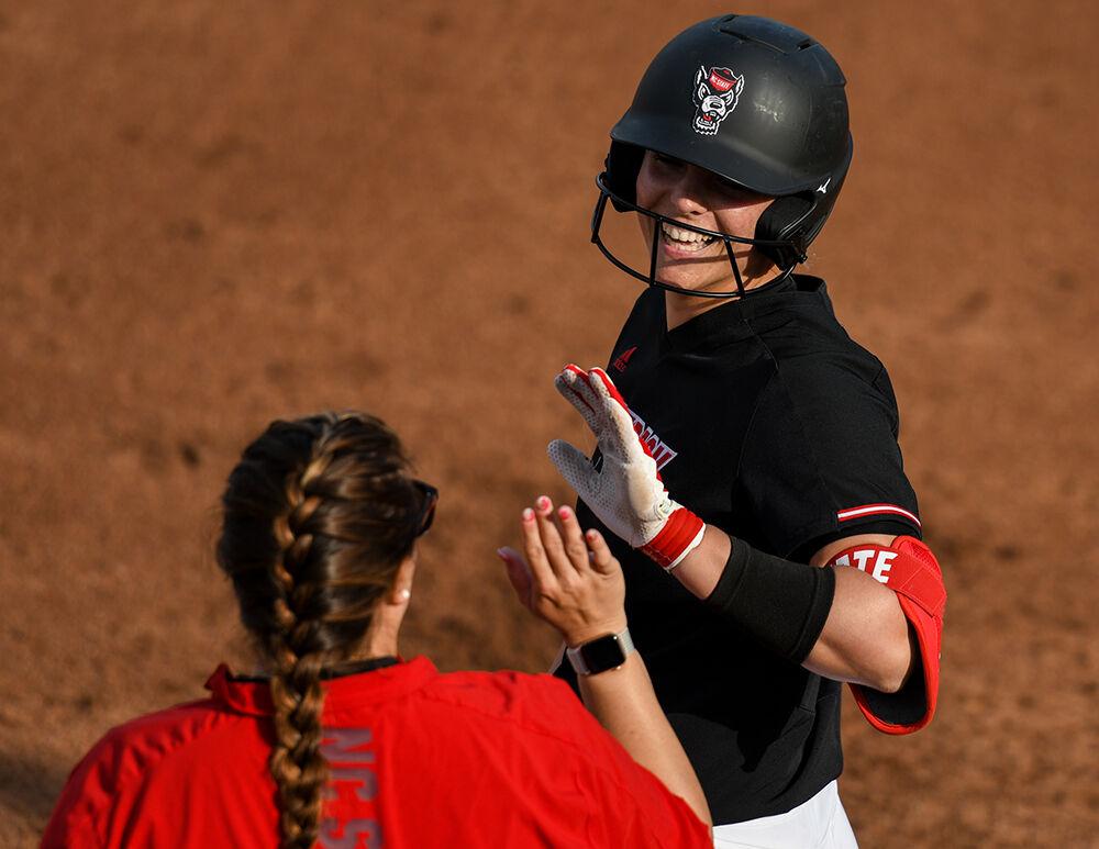 Redshirt sophomore infielder gets a high five at first base during the game versus the Campbell Camels on Tuesday, March 22, 2022 in Dail Softball Stadium. Whittaker had one hit against Campbell. The Wolfpack beat the Camels 2-0.