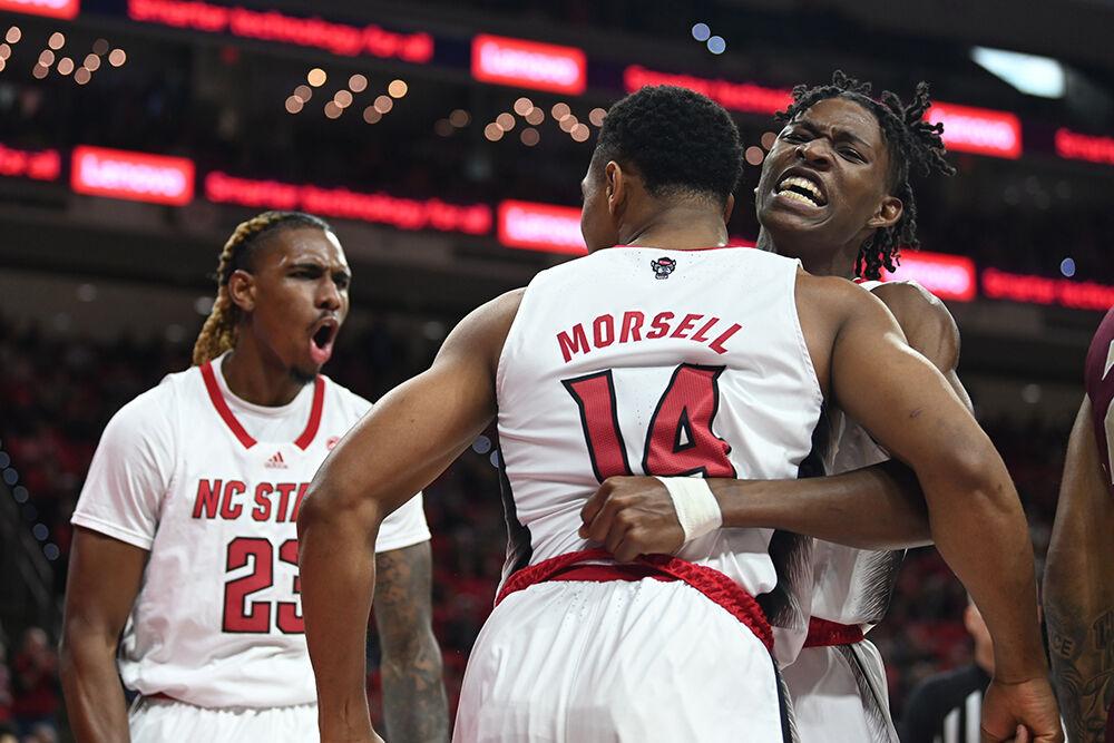 Redshirt junior forward Greg Gannt (left), celebrates as sophomore guard Terquavion Smith (right) hugs senior guard Casey Morsell during the Wolfpack's home basketball game against the Florida State Seminoles in PNC Arena on Wednesday, Feb. 1, 2023. The Wolfpack beat the Seminoles 94-66.