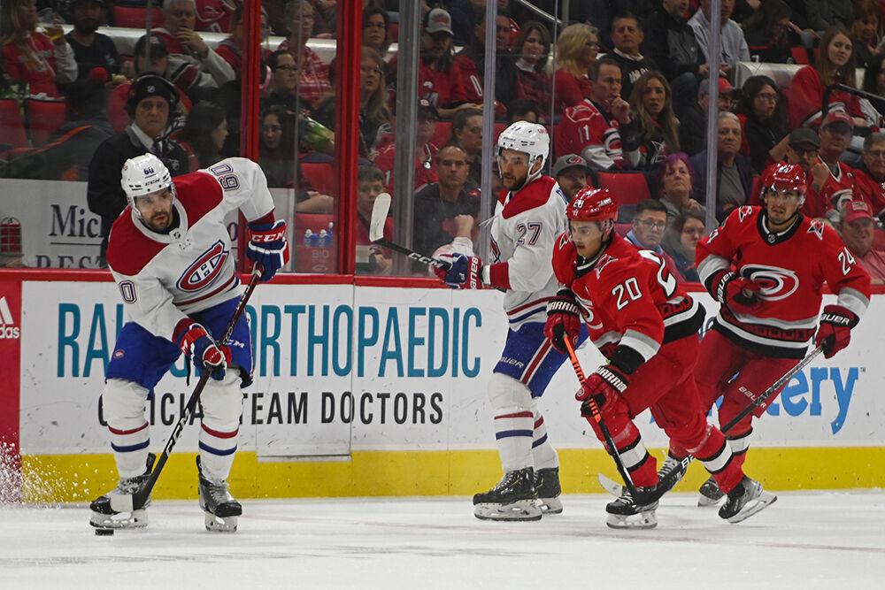 Carolina Hurricanes Sebastian Aho defends opponent during the game against the Montreal Canadiens in PNC Arena on Thursday, Feb. 16, 2023. The Hurricanes won 6-2.