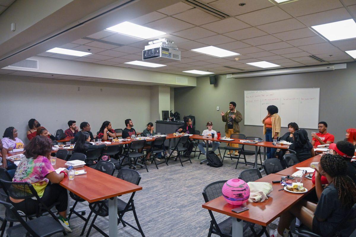 Isaac Davis, a third-year studying mathematics, introduces the event in the African American Cultural Center on Wednesday, Feb. 15, 2023. At the Black History Month Chat n' Chew students discussed several poems about the black experience.