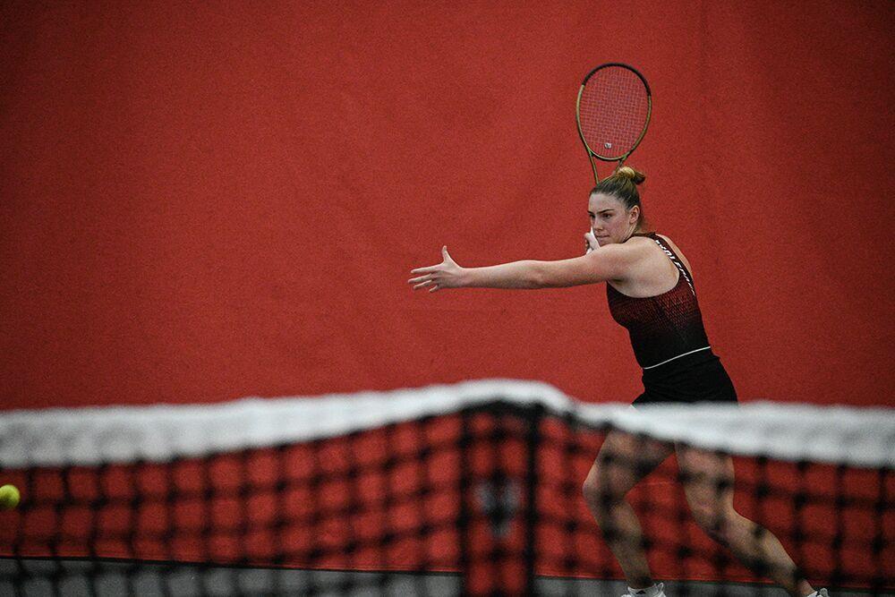 Junior Amelia Rajecki makes a forehanded hit during her singles match against Oklahoma player Dana Guzman at J.W. Isenhour Tennis Center on Saturday, Feb. 4, 2023. Rajecki won the singles match and NC State beat Oklahoma 6-1.