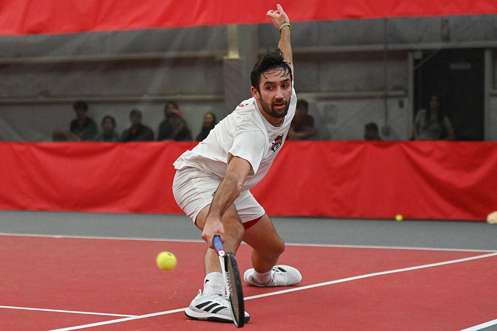 Fifth-year Rafa Izquierdo Luque lunges forward to return the ball during the singles match against Michigan at J.W. Isenhour Tennis Center on Friday, Feb. 10, 2023. NC State lost 4-0 to Michigan.