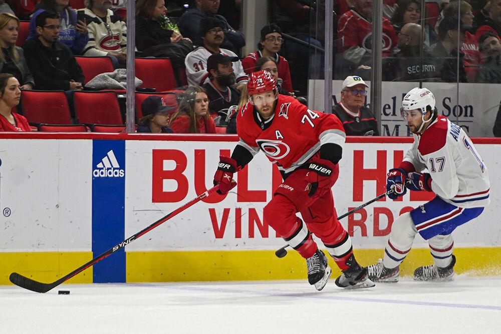 Carolina Hurricanes defenseman Jaccob Slavin dribbles the puck away from opponent during the game against the Montreal Canadiens in PNC Arena on Thursday, Feb. 16, 2023. The Hurricanes won 6-2.