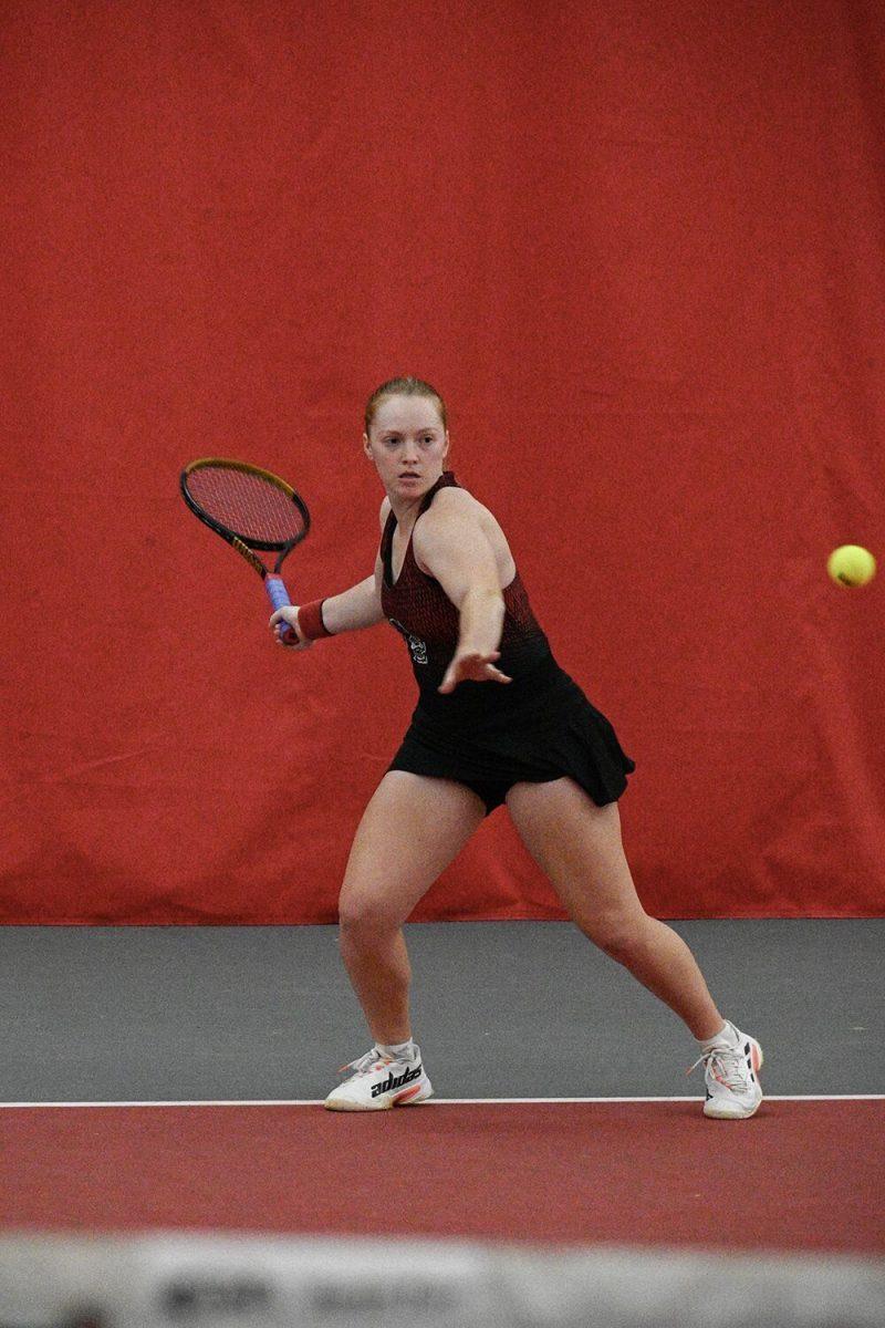 Junior Sophie Abrams keeps her eye on the ball during the singles match against Oklahoma player Julia Garcia Ruiz at J.W. Isenhour Tennis Center on Saturday, Feb. 4, 2023. Abrams won her singles match and NC State beat Oklahoma 6-1.&#160;