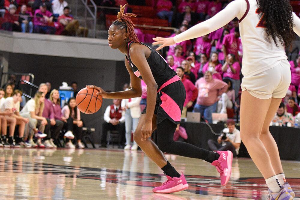 Sophomore guard Saniya Rivers keeps the ball away from defenders during the game against Virginia Tech at William Neal Reynolds Coliseum on Mon. Feb. 6, 2023. The Play4Kay event was held during the game as a memorial to former head coach Kay Yow and a celebration for all who have suffered from breast cancer. Virginia Tech won 73-61.