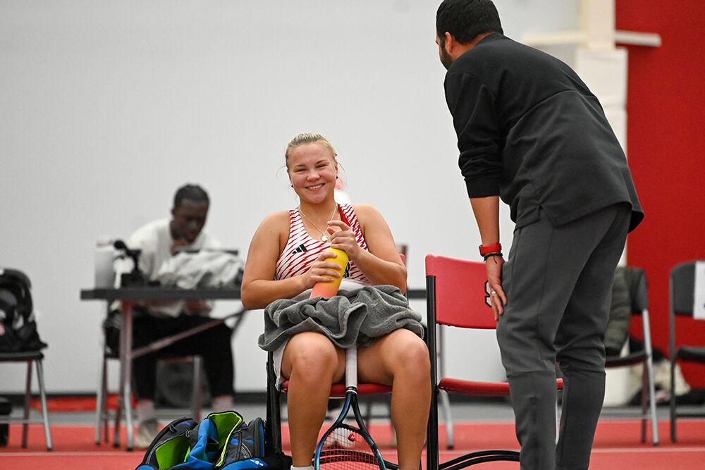 Freshman Diana Shnaider smiles while talking to assistant coach David Secker during the match against Tennessee at J.W. Isenhour Tennis Center on Sunday, Feb. 5, 2023. NC State beat Tennessee 6-1.