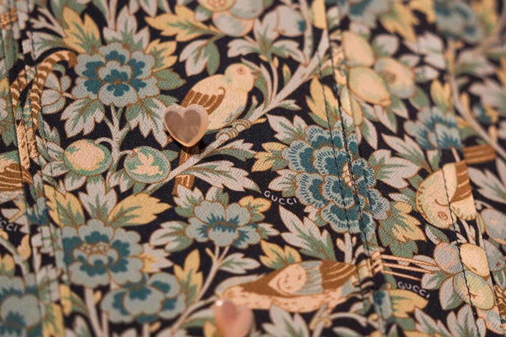 Details of buttons and stitching on a custom-made Gucci dress worn by Taylor Swift her 2020 video for "Willow" on display in The Power of Women in Country Music exhibit at the NC Museum of History on Friday, Feb. 3, 2023. The exhibit features four notable dresses worn by Swift throughout her career, as well as boots, a banjo and a set recreation from her 2021 Grammy's performance.