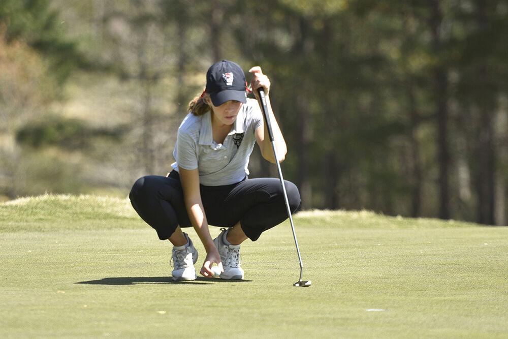 Redshirt junior Nicole Kramer marks the ball on the green during the Wolfpack Match Play at Lonnie Poole Golf Course on Sunday, April 3, 2022. NC State came in third in the event.