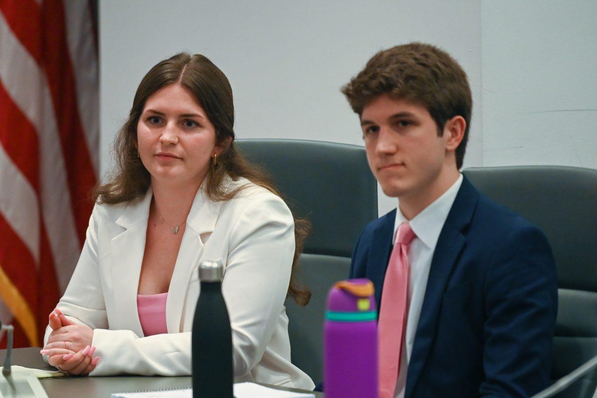 Nina Kudlak, a third-year studying political science, and Will Vuncannon, a third-year studying political science listen to a question during the debate held by Technician and Nubian Message in Talley Student Union on Friday, March 3, 2023.