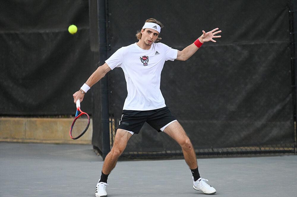 Senior Robin Catry backhands the ball during the match against Notre Dame at Dail Outdoor Tennis Stadium on Friday, March 24, 2023. Catry won his singles match. NC State beat Notre Dame 4-0.