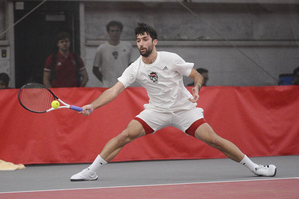 Graduate student Rafa Izquierdo Luque reaches for the ball in the match against Michigan at the J.W. Isenhour Tennis Center on Friday, Feb. 10, 2023. NC State lost 4-0 to Michigan.