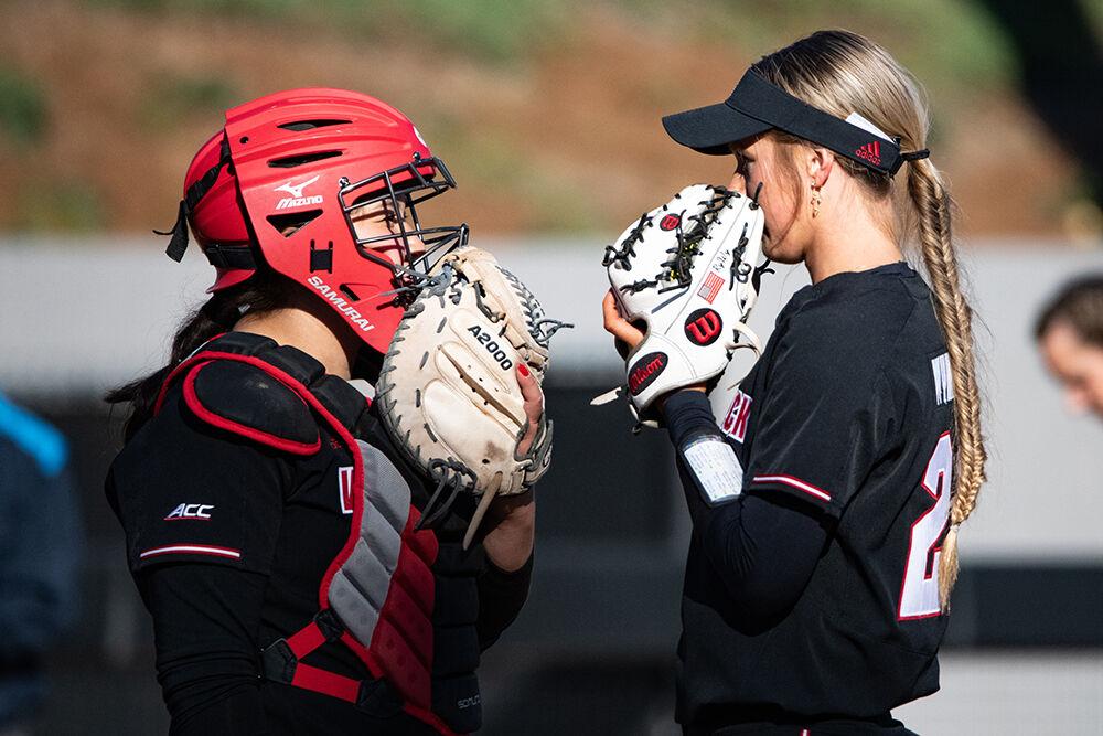 Freshman catcher Amanda Hasler and freshman pitcher Rylee Wyman discuss during the game against Notre Dame at&#160;Dail Softball Stadium on Saturday, March 11, 2023. The Wolfpack lost to the Fighting Irish 10-3.