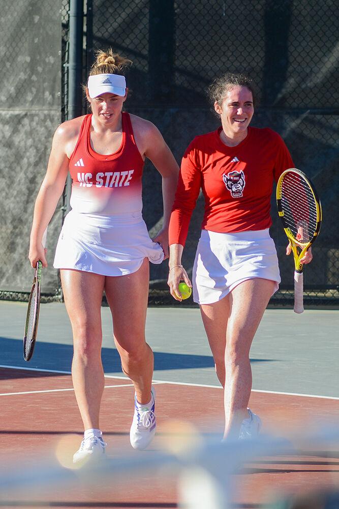 Junior Amelia Rajecki (left) and graduate Nell Miller (right) talk between sets during their doubles match against East Tennessee State University at the Dail Outdoor Tennis Stadium on Sunday, March 5, 2023. Rajecki and Miller won their set 6-2. NC State beat ETSU 7-0.