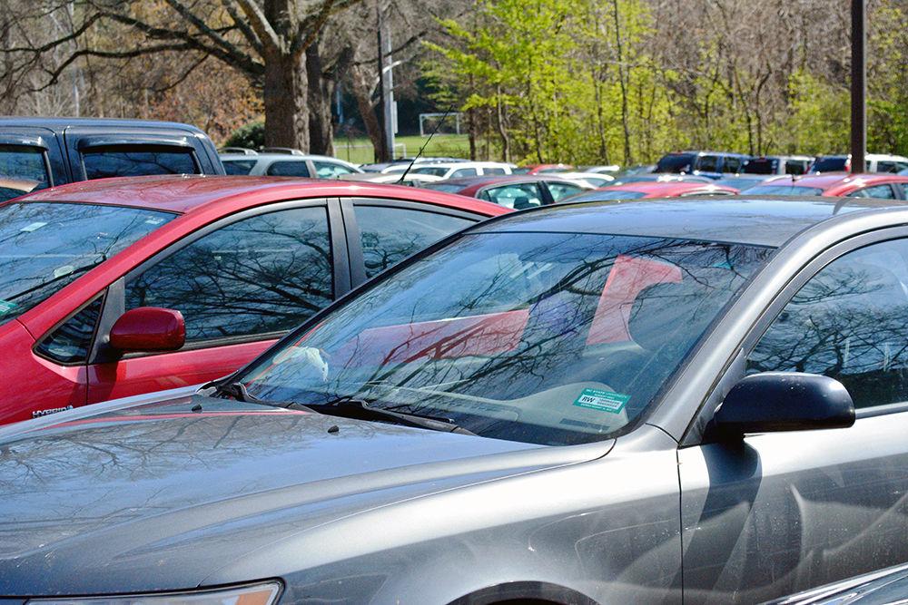 Student cars parked in the Lee parking lot on Tuesday, March 14, 2018. Currently, students place their parking permits on their front windows and are allowed to park forward or back into their spaces, but this system will soon be changing.