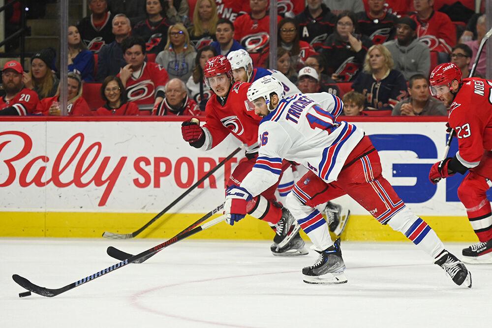 Carolina Hurricanes right wing Jesper Fast defends a New York Ranger opponent in PNC Arena on Thursday, March 23, 2023. The Hurricanes lost 2-1.
